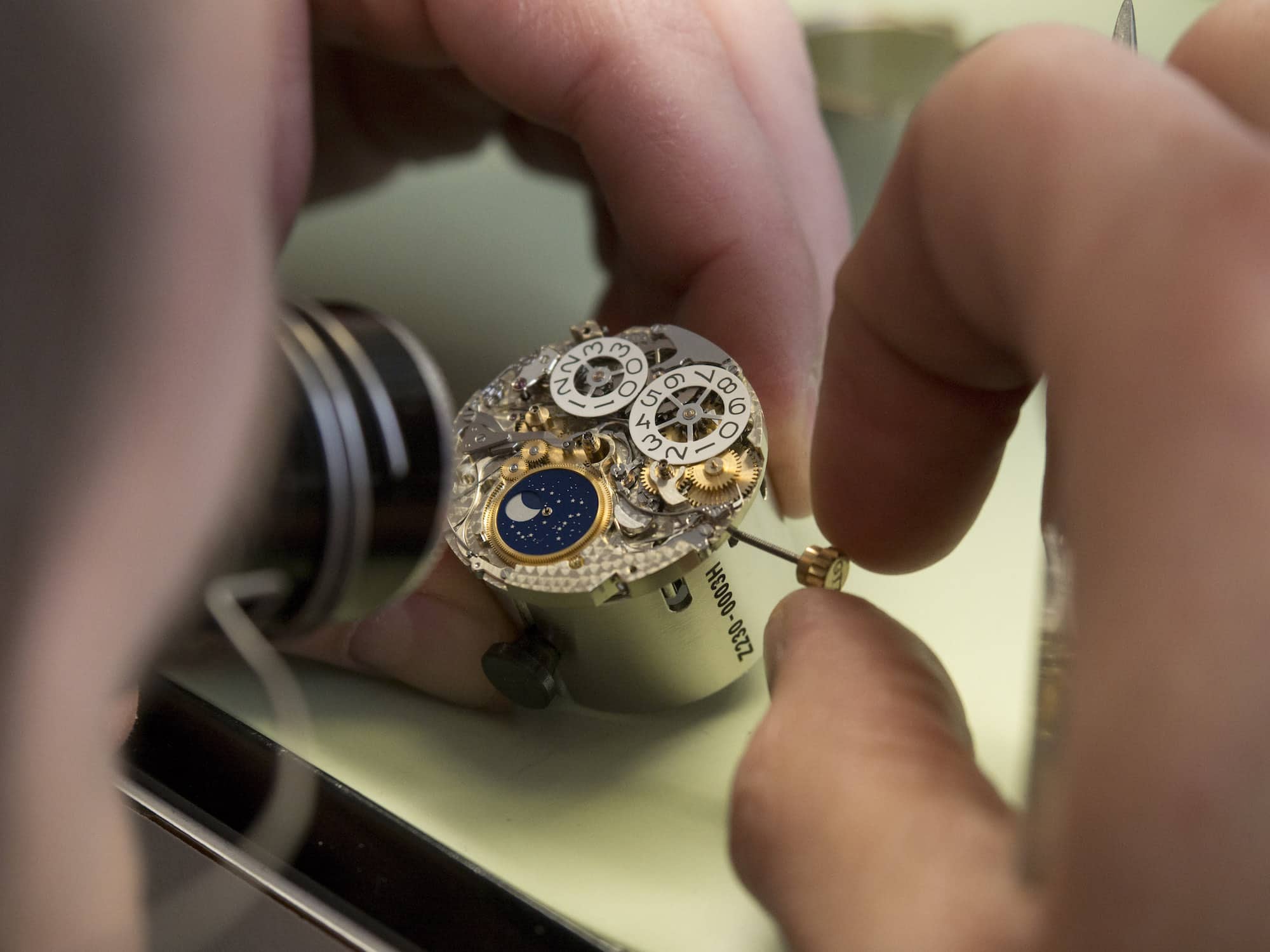 A watchmaker working on the mechanisms of the perpetual calendar in a Chopard L.U.C 03.10-L.