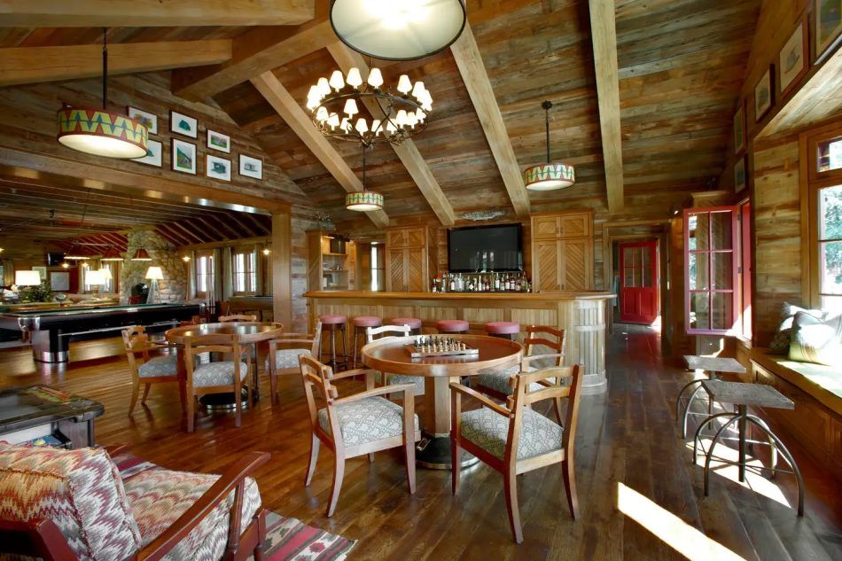 Bruce Fox converted a former Boy Scout camp outside Chicago into a relaxed family compound, with the former craft lodge reimagined as a bar and game room.