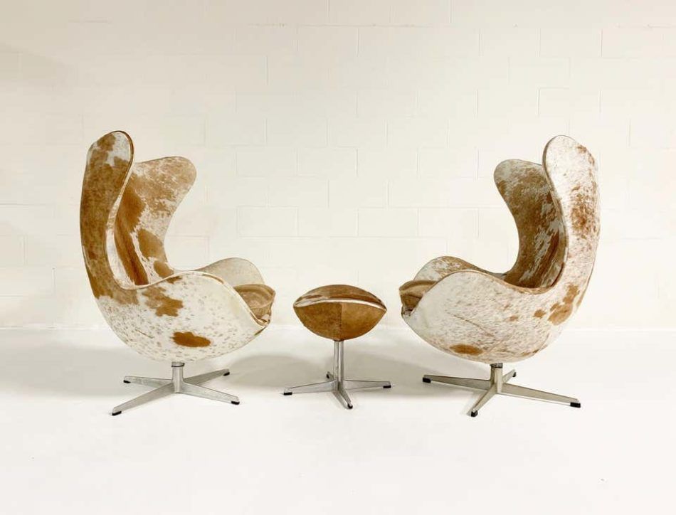 Egg chairs and ottoman reupholstered in Brazilian cowhide.