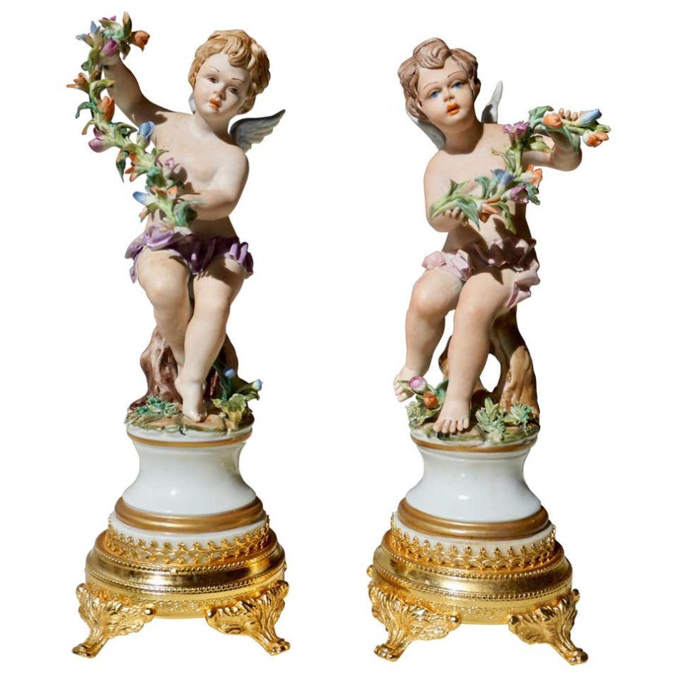 Pair of porcelain Capodimonte putti figures, mid-20th century