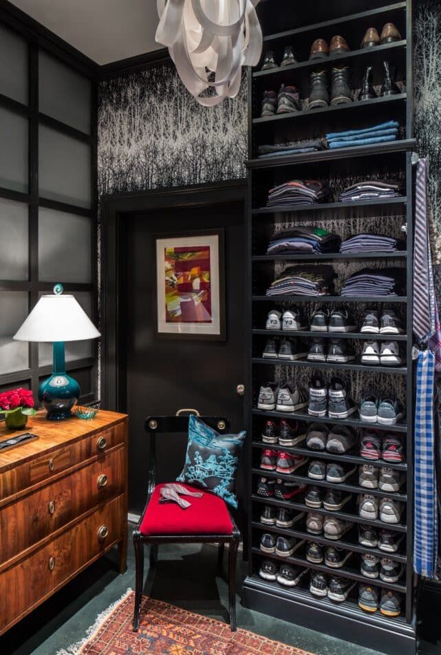 a dark masculine closet with a red and black chair