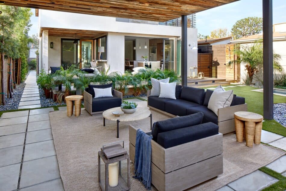 a patio with a seating area and a jute rug