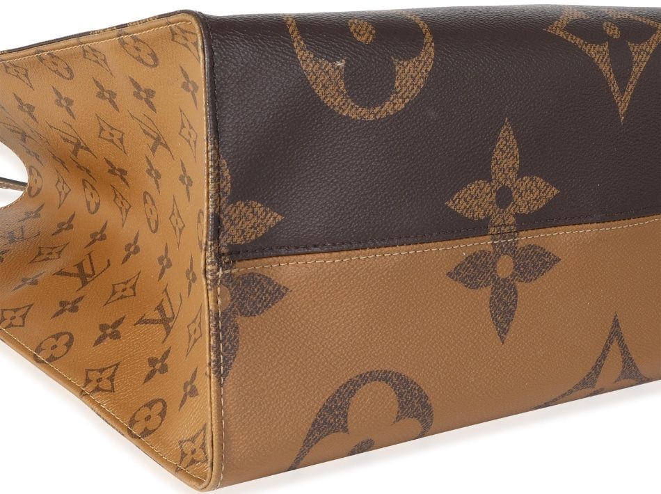 A photograph of the two-tone bottom of a Louis Vuitton Monogram Reverse Giant Onthego GM. 