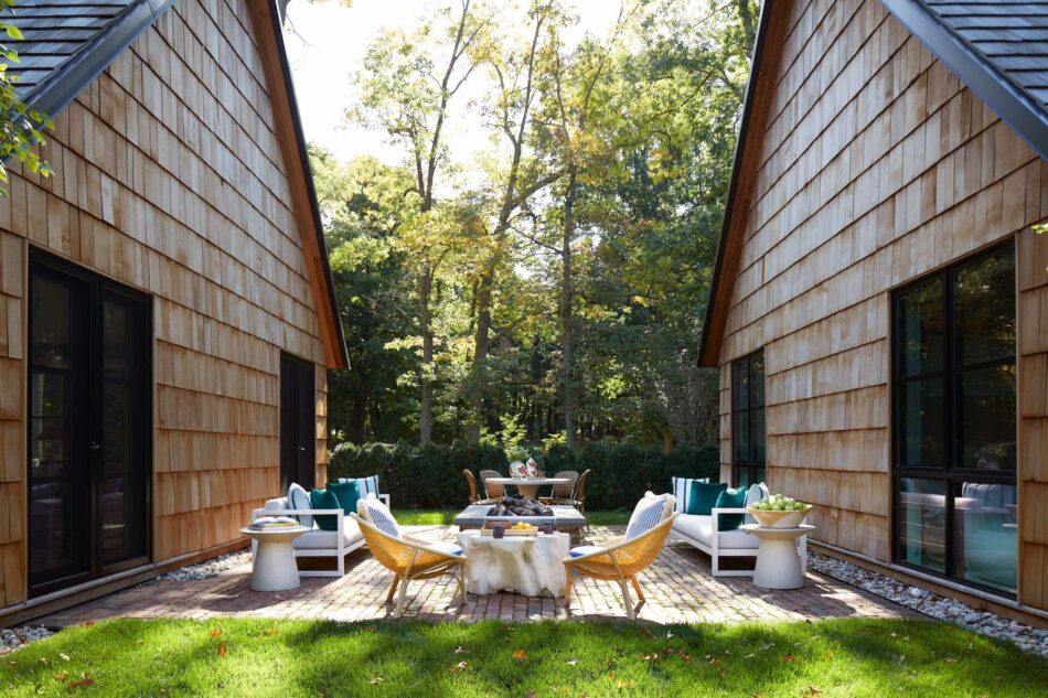 a patio between two shingle style buildings