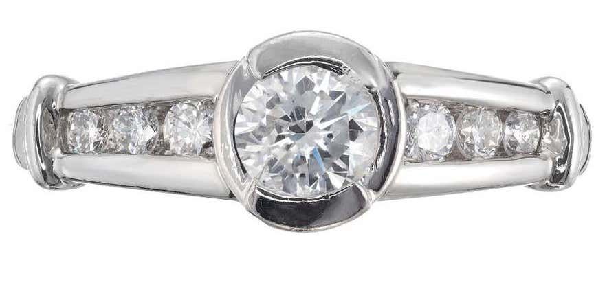 A semi-bezel channel-set diamond engagement ring made with platinum