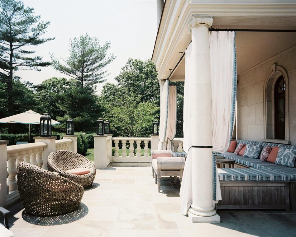 a patio with an L-shaped sofa and barrel chairs