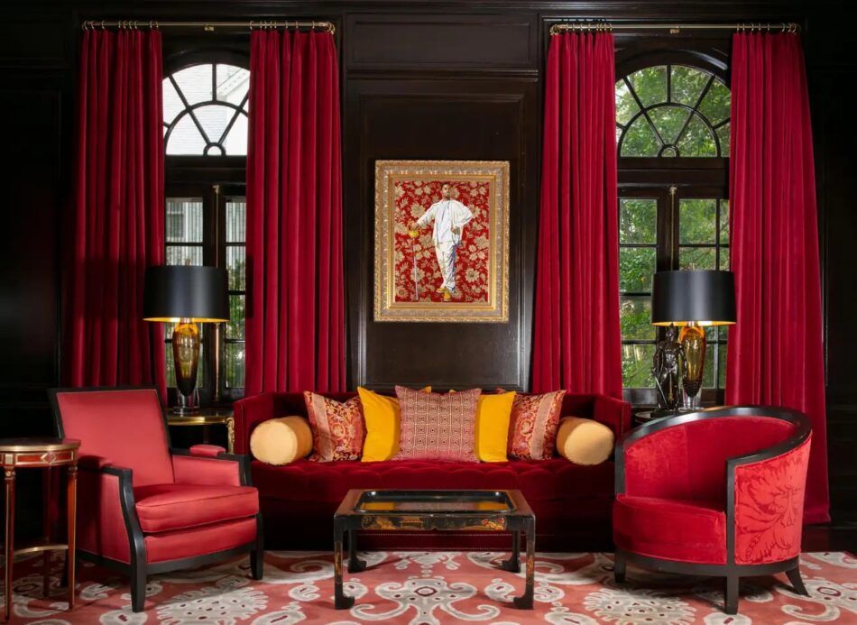 red living room with Kehinde Wiley painting and tea table from Kennedy White House