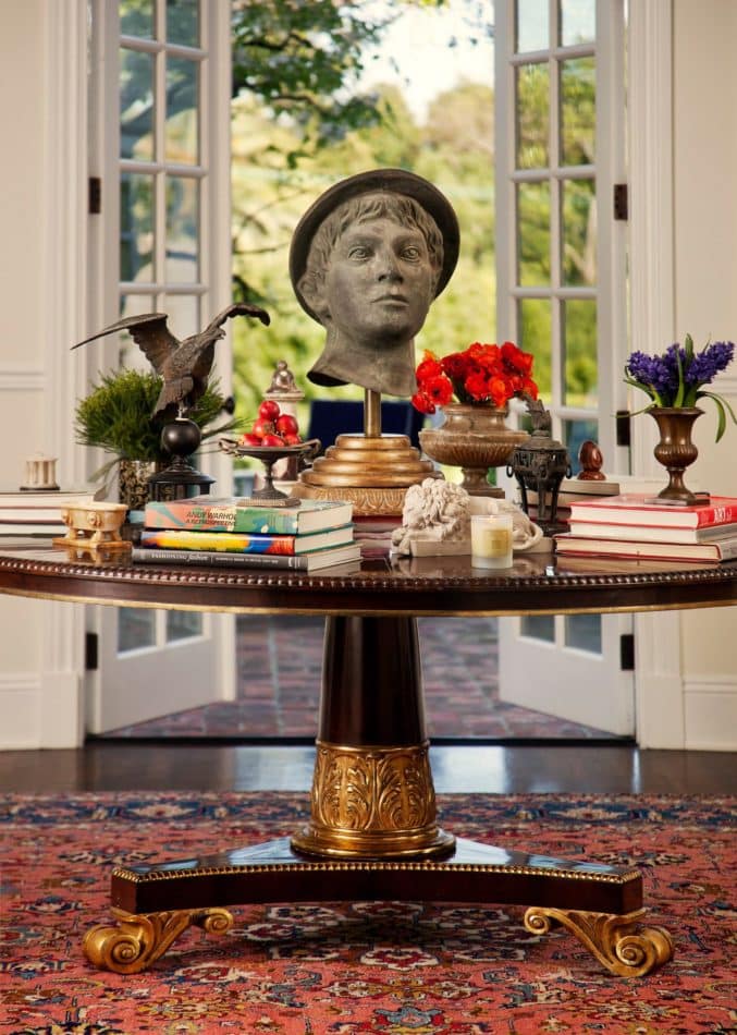 Foyer with a bust on the center table, designed by Timothy Corrigan