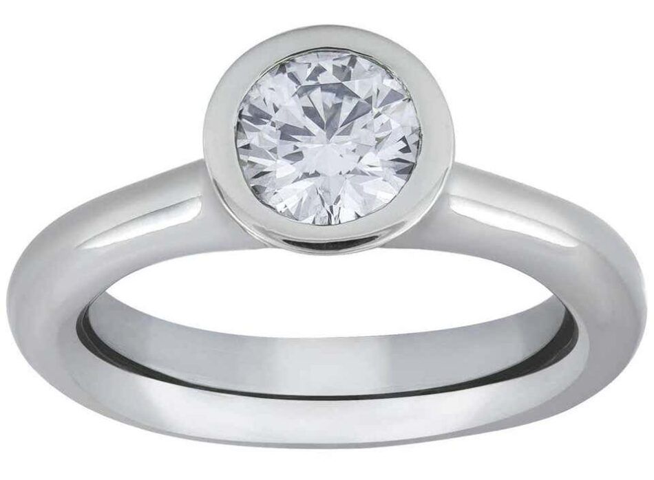A bezel-set solitaire engagement ring made with platinum 