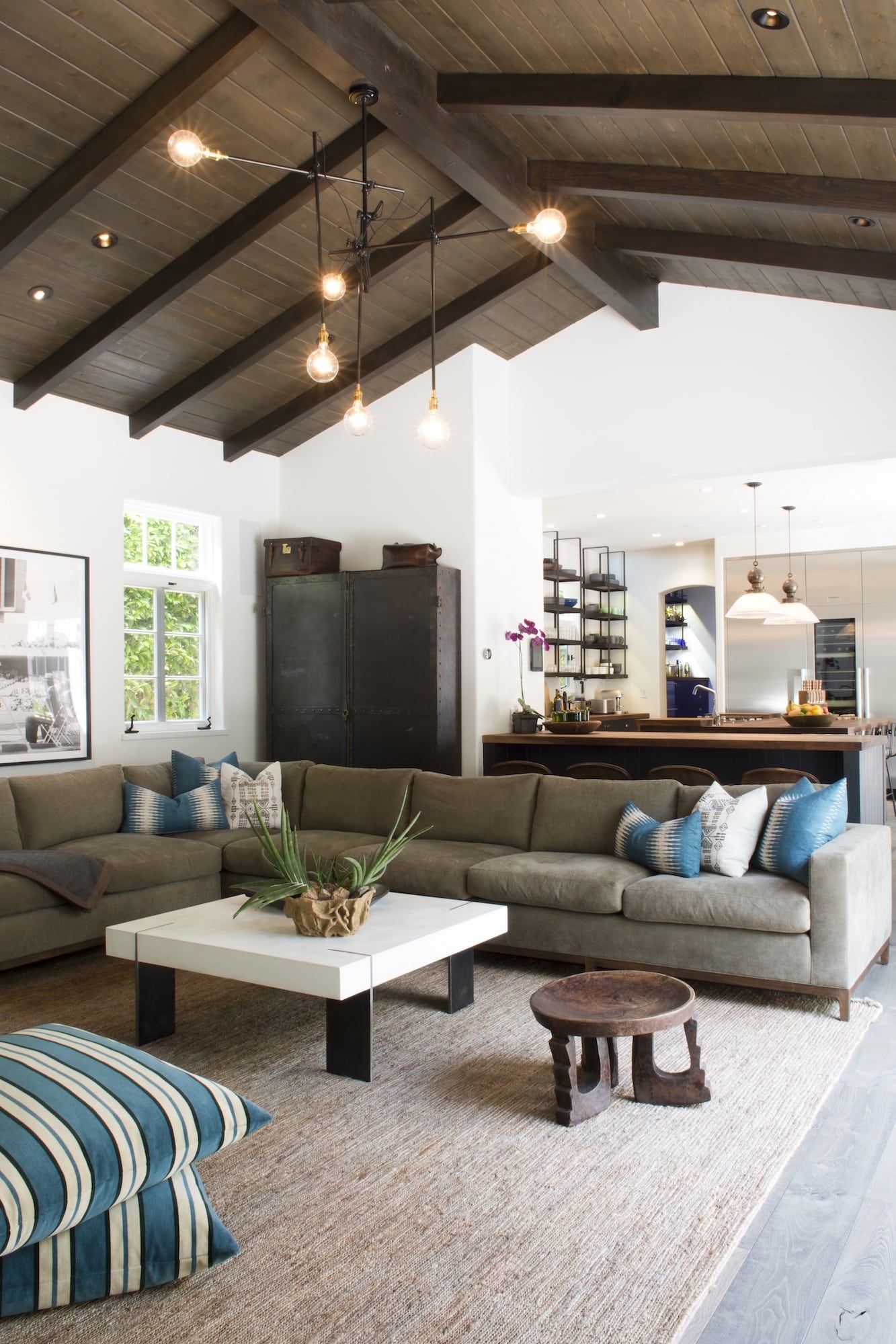 The family room in Kevin Yorn's Los Angeles home features a Coup D’Etat concrete coffee table, a stool by Blackman Cruz and a steel armoire from Galerie Half