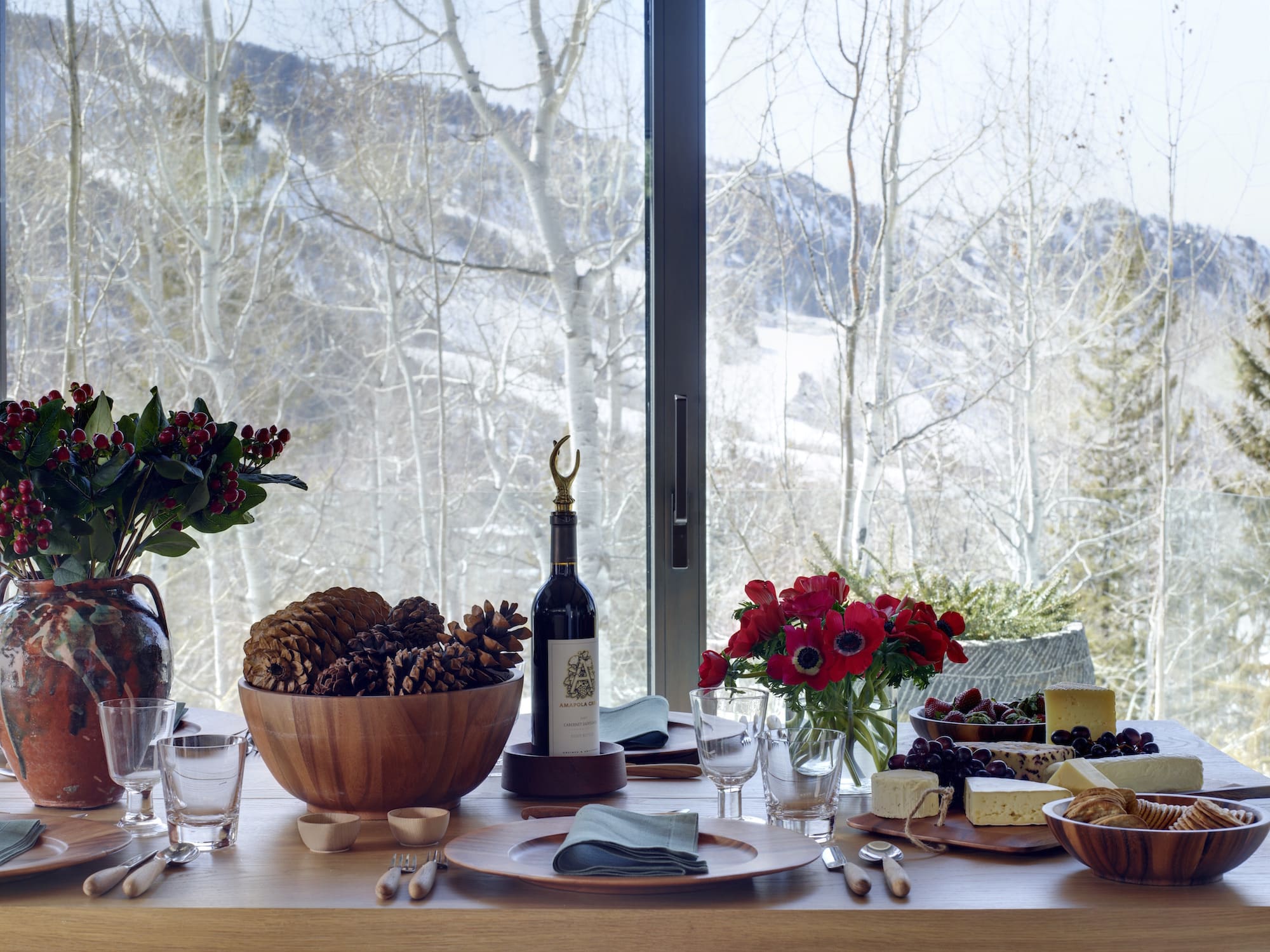 A tablescape and mountain view in Aerin Lauder's Aspen house designed by Daniel Romualdez.