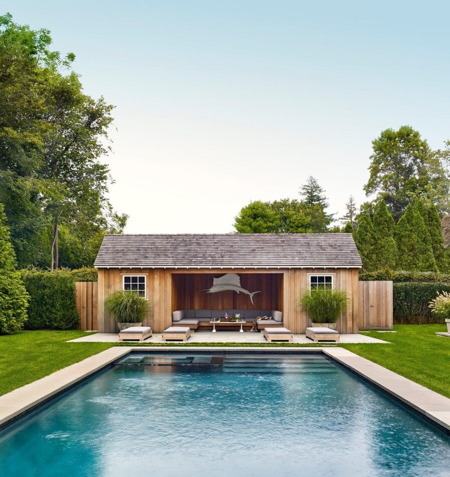 Dan Scotti's wood-sided pool house with a fish sculpture