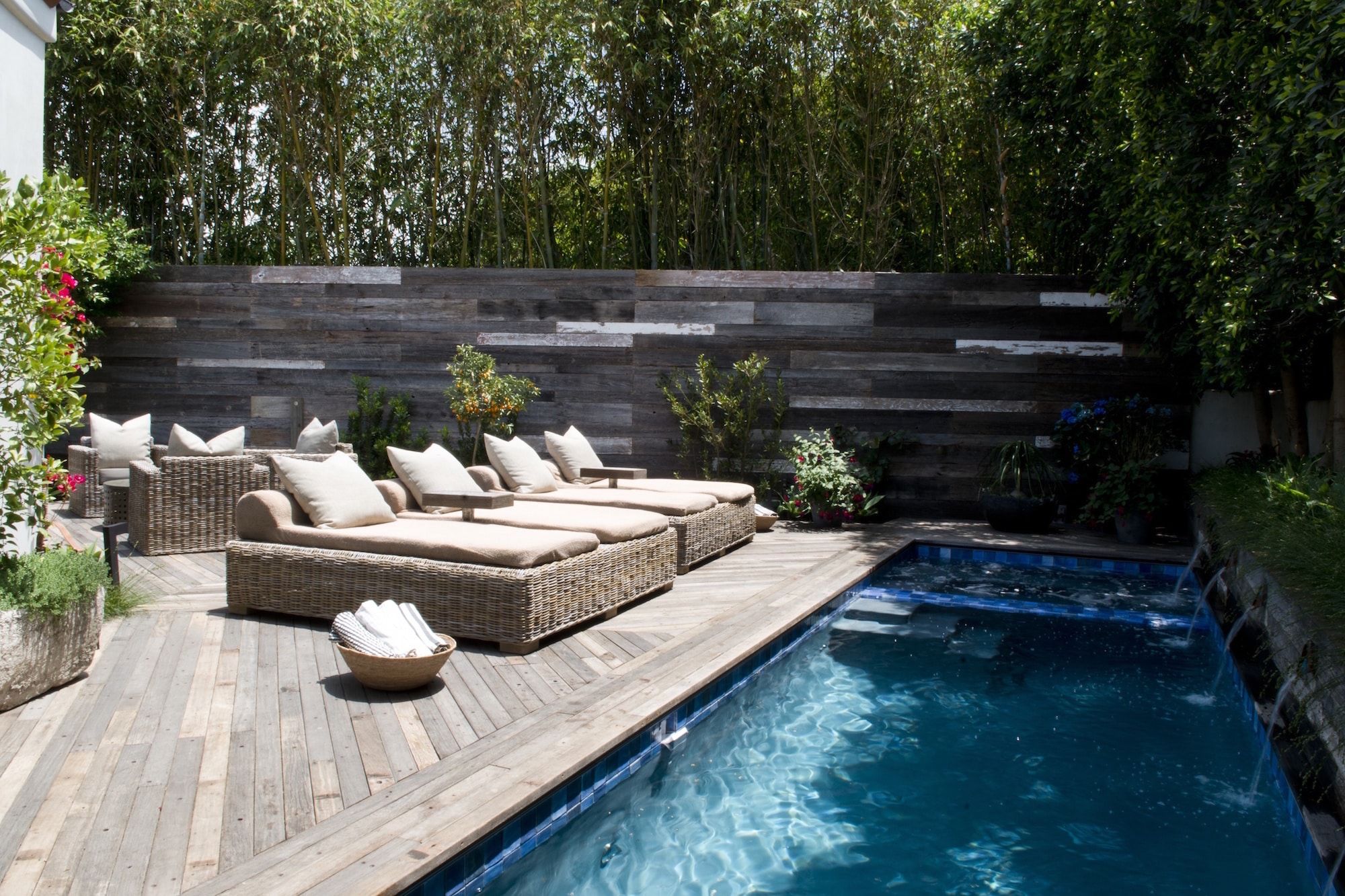 The swimming pool area at Kevin Yorn's Los Angeles home features a lot of reclaimed materials