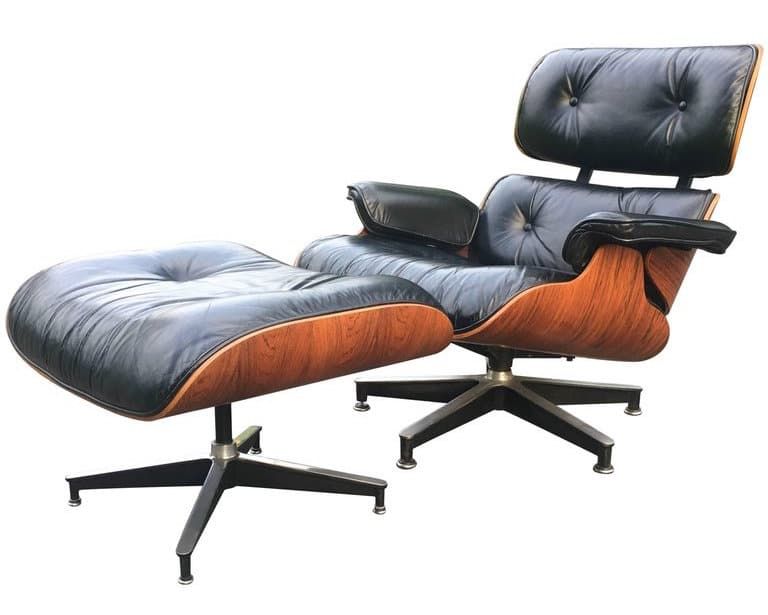 An Eames lounge chair and ottoman upholstered in black leather