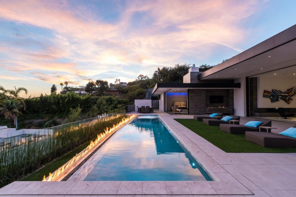 Alissa Sutton devised this modern hillside house in Los Angeles from the ground up, placing its outdoor living spaces toward wide vistas of the city below. A natural-gas fire feature runs along the pool, creating a dramatic focal point.