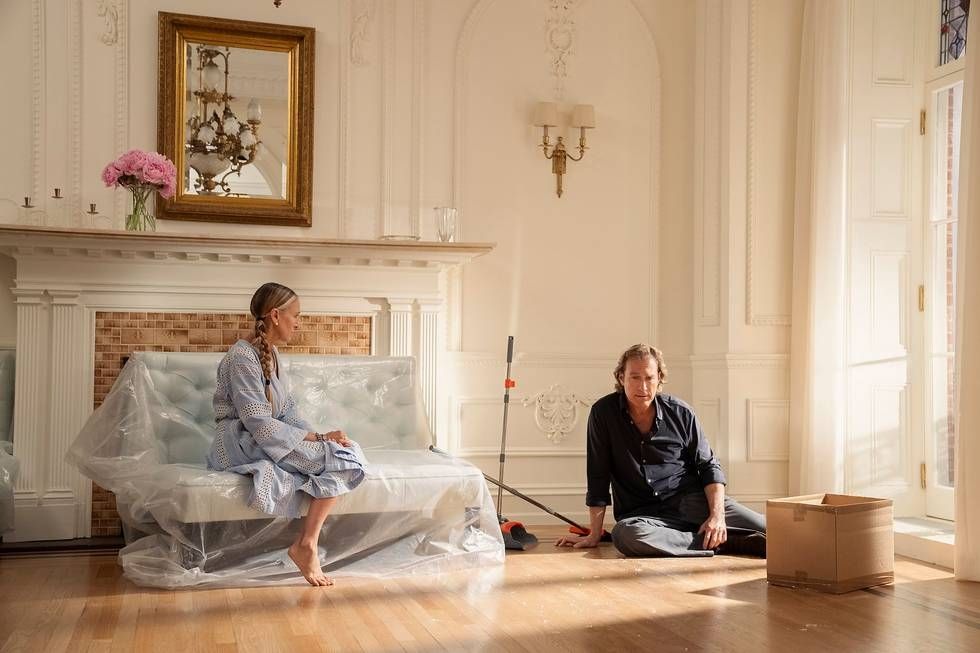 Carrie Bradshaw and Aidan sit in their Gramercy Park apartment