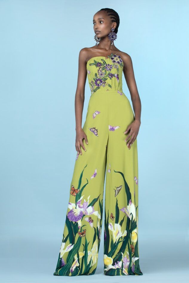 woman wearing green jumpsuit with butterfly and flowers painted on the legs