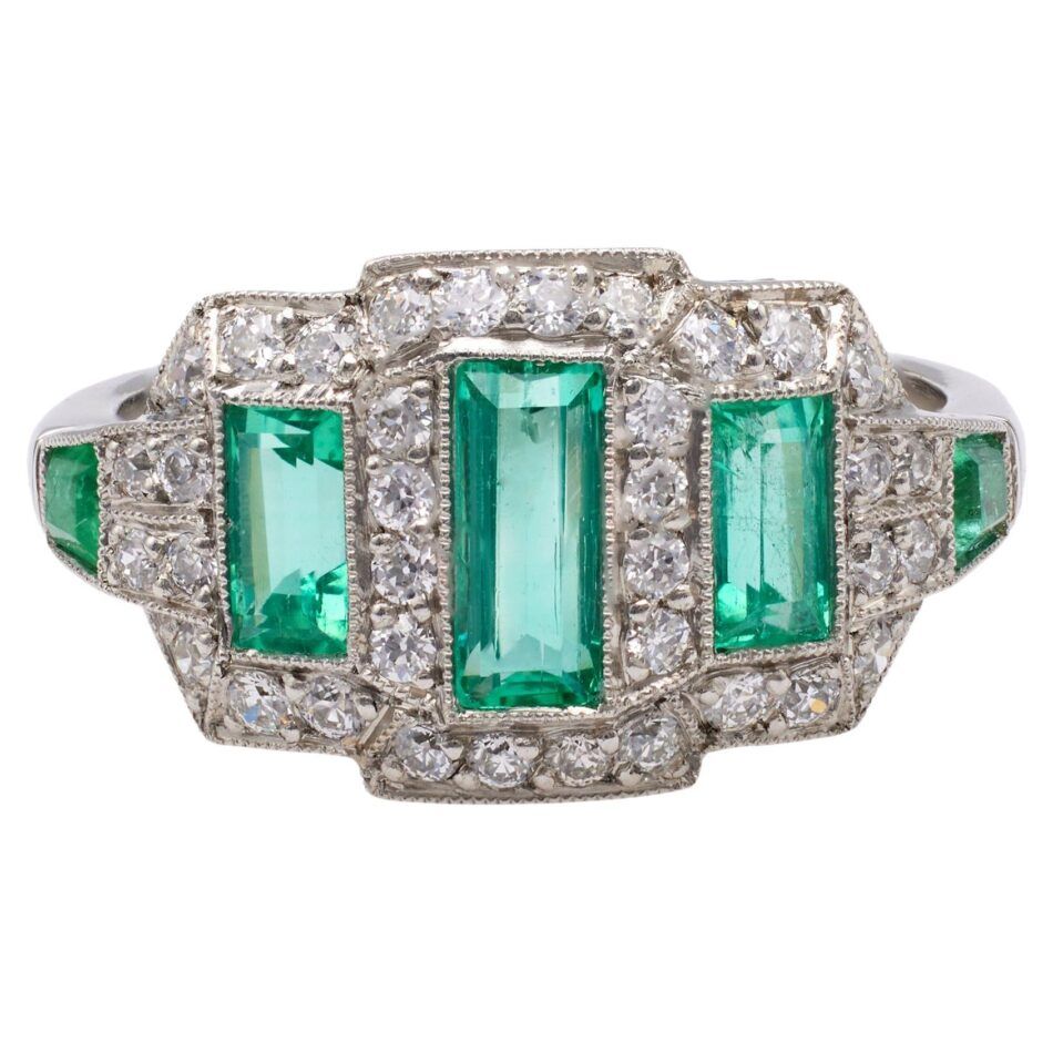 An Art Deco-inspired engagement ring with baguette-cut emeralds surrounded by a halo of diamonds