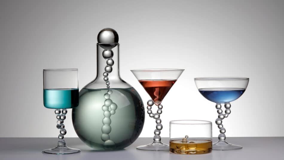 Atelier Crestani's Alchemica decanter and wine, martini, old fashioned and manhattan glasses, each filled with a different color liquid