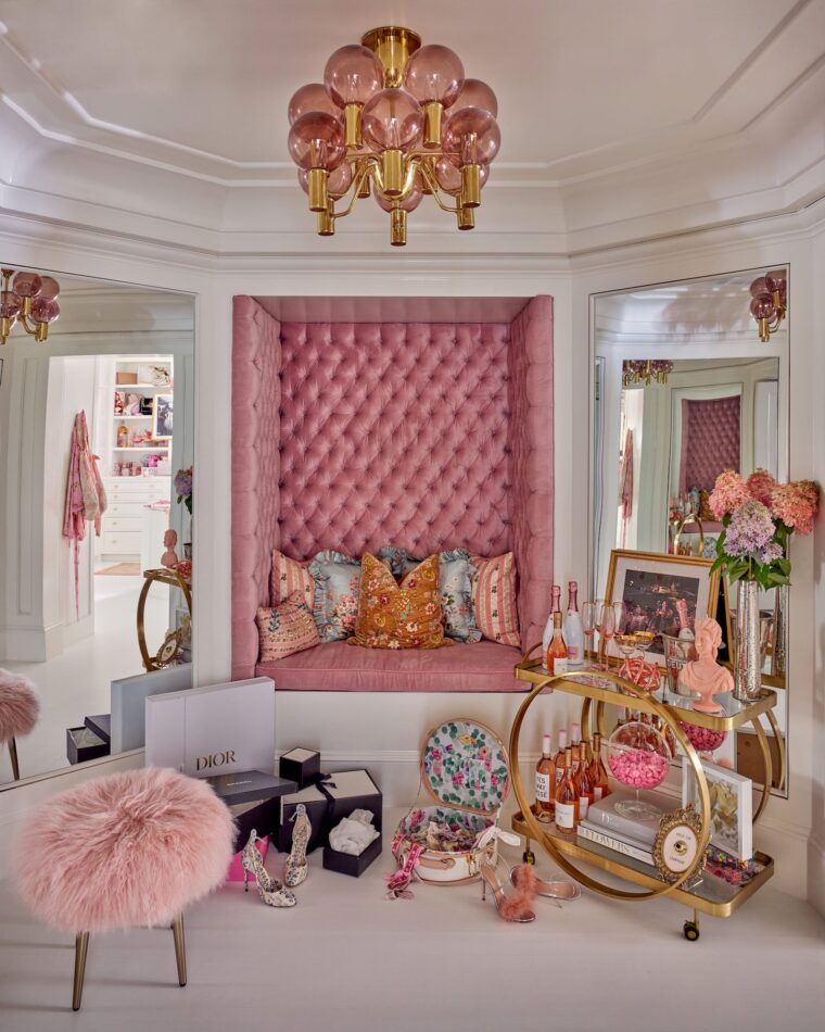 a pink dressing room with a fluffy stool