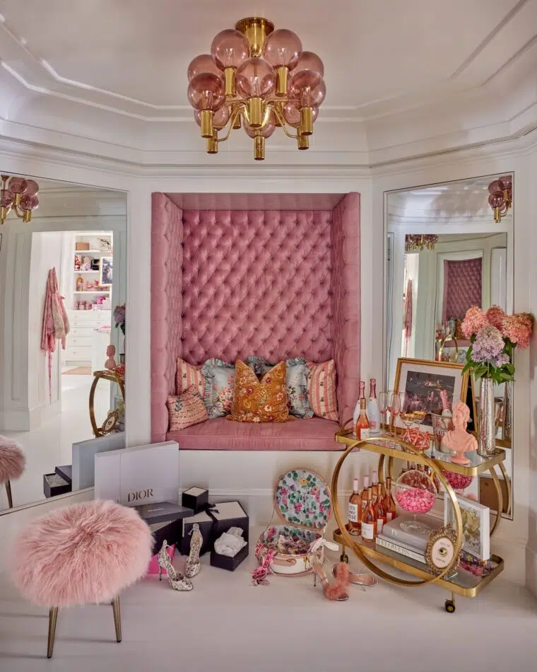 a pink dressing room with a fluffy stool