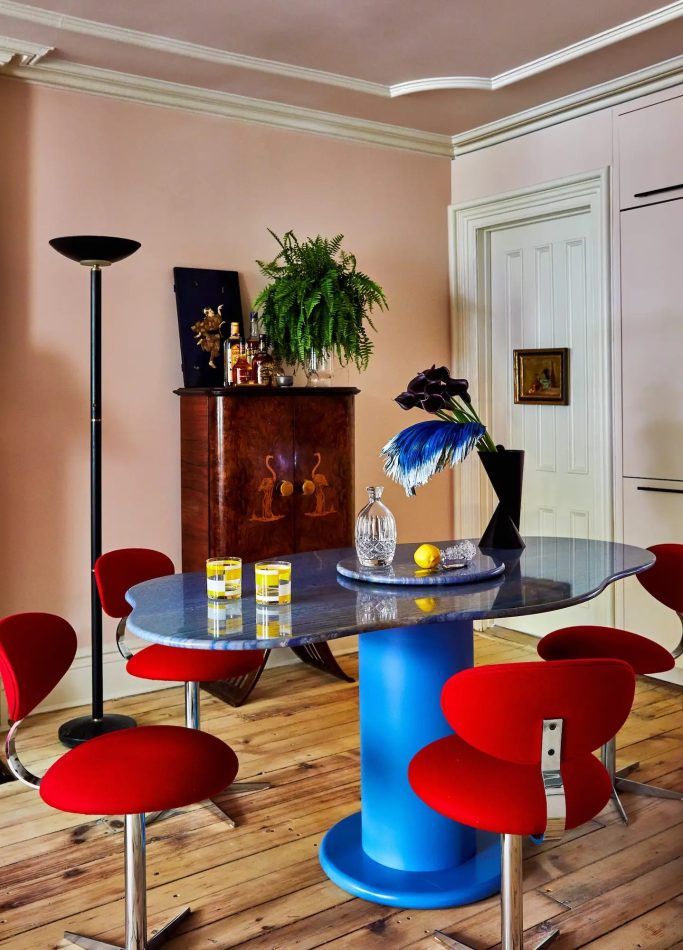 The dining-and-cocktails area of a Brooklyn dining room by Darren Jett has a custom table, 1970s chairs and a 1930s Italian Art Deco dry bar by Luigi Scremin.