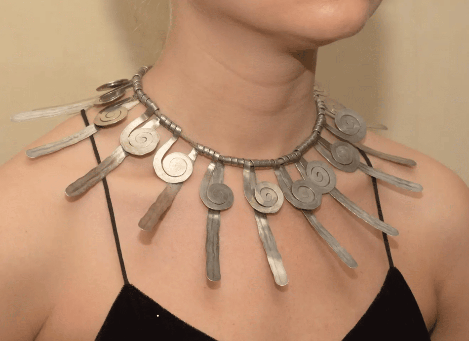 A model wearing an Alexander Calder hammered-silver mid-century necklace