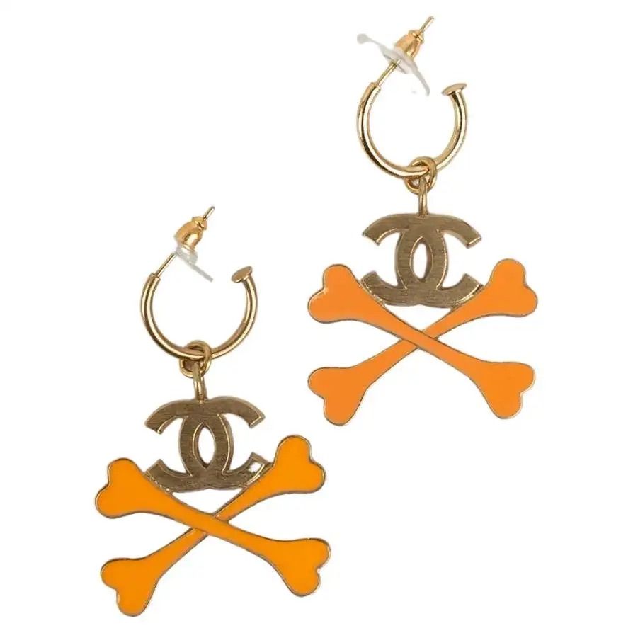 earrings with chanel logo and orange cross bones