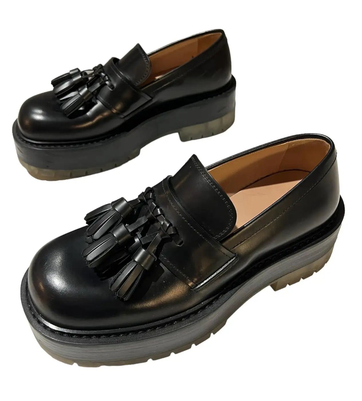Black loafers with three tassels and a platform sole.