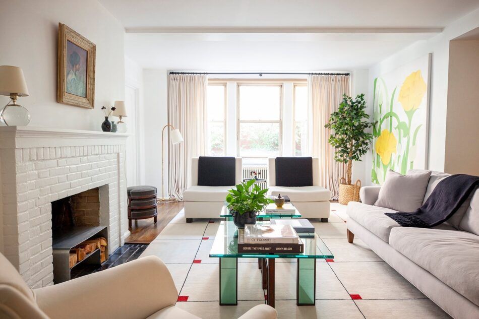 living room with a green coffee table and a white rug with red details