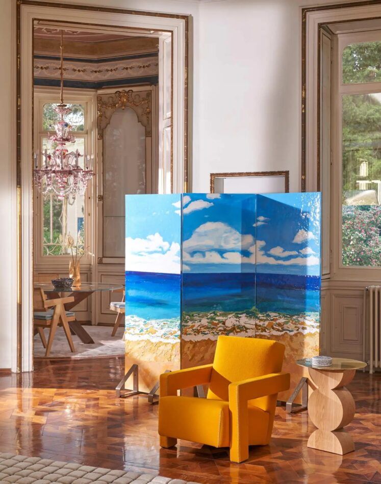 Gaetano Pesce’s 2023 Paravento Risacca (Undertow Screen) paired with a saffron-color arm chair and a sculptural side table in a traditional room with gilded moldings and parquet floors