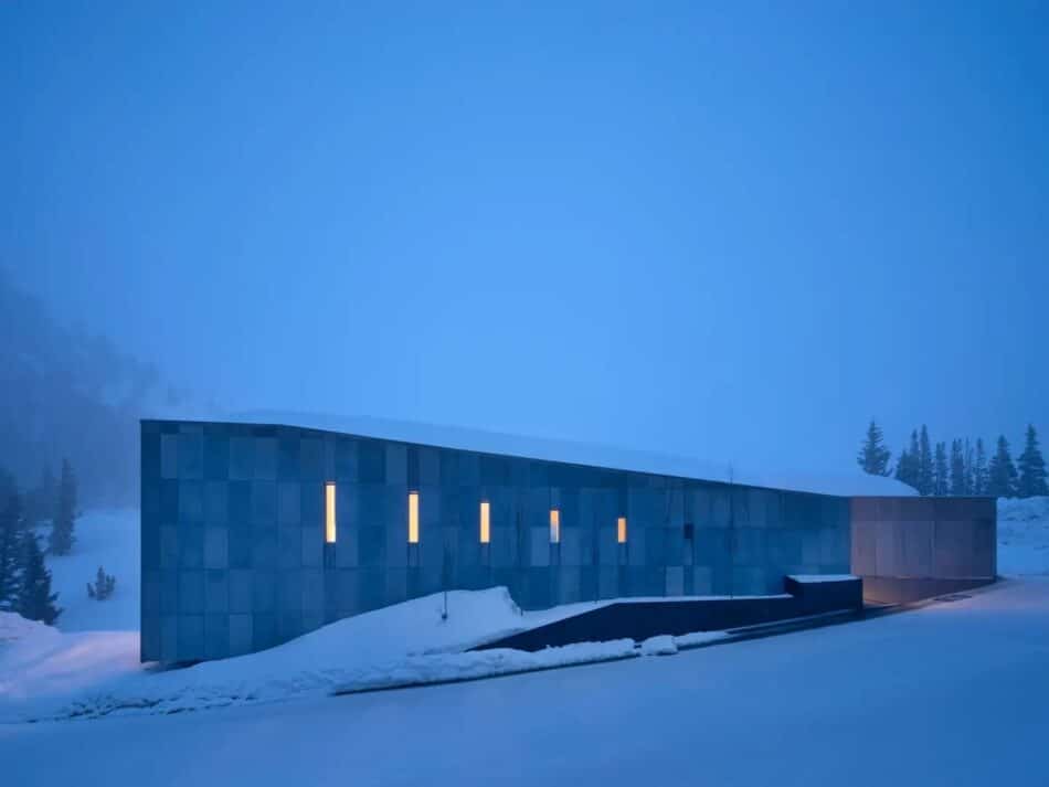 Exterior of an Alta, Utah, home by DHD Architecture & Interior Design in the snow at twilight