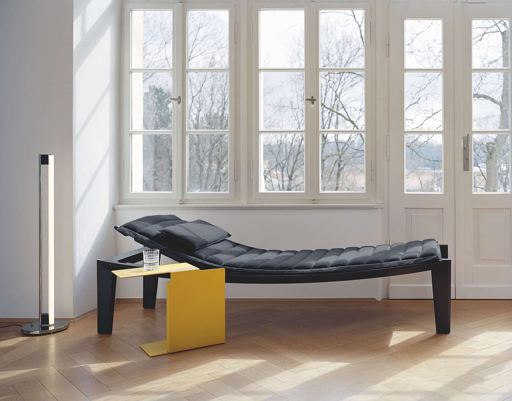 Konstantin Grcic's Ulisse daybed and Diana A side table accompanied by Eileen Gray's Tube light, 1927