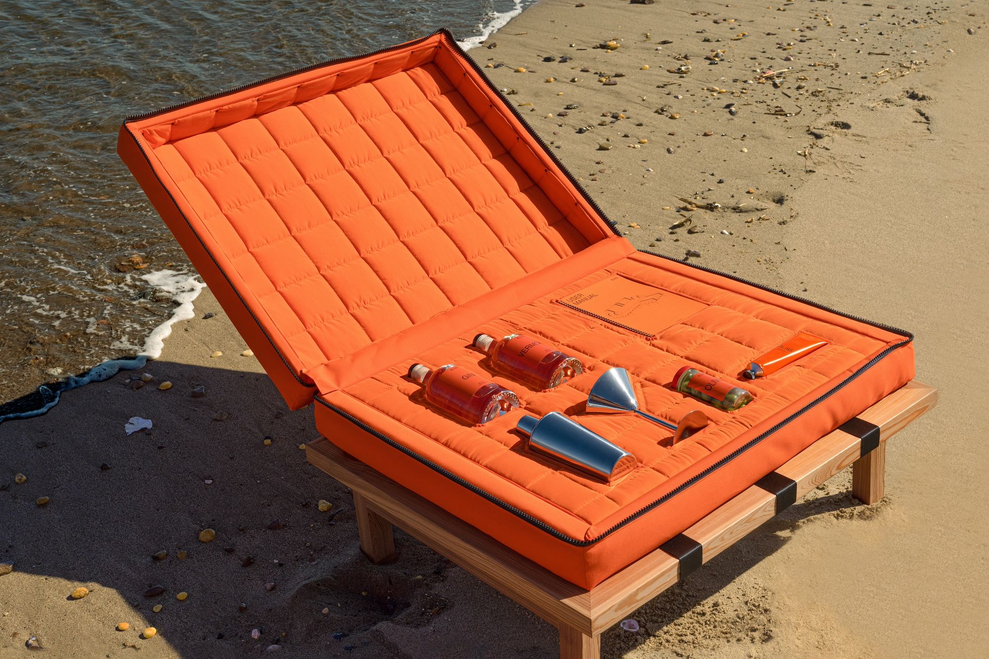 A martini kit, a tube of sunscreen and a user's manual are nestled inside the ottoman of the Bliss sofa.