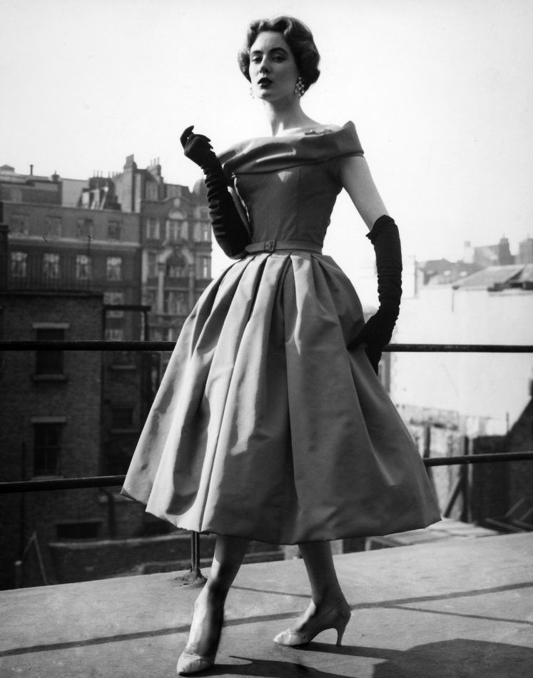 A model wears a Christian Dior cocktail dress in London in 1956.