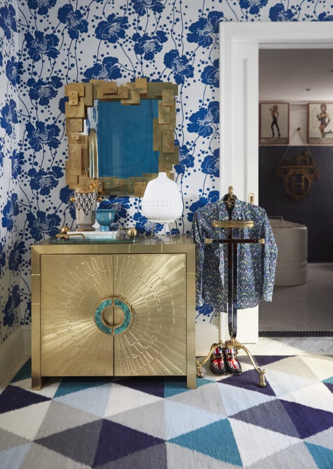 a bold closet with lots of blue and a gold armoire