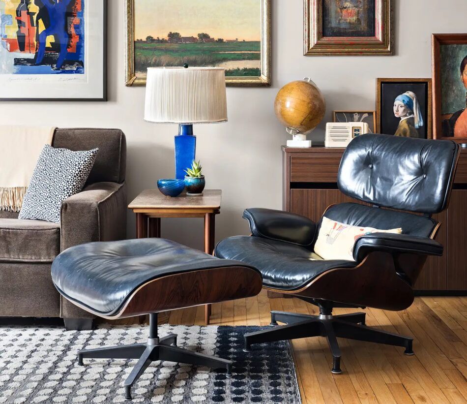 A mid-century-inspired Manhattan living room designed by ECC Interiors with a black leather Eames Lounge Chair and Ottman