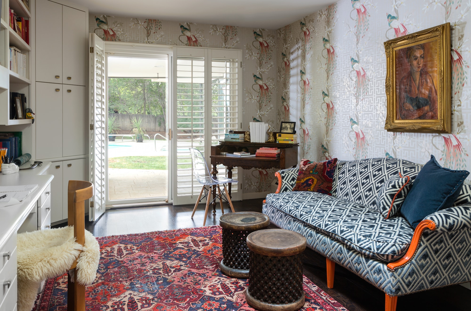 Andrea Schumacher’s own study in Bow Mar, Colorado, holds true to her curated-over-time philosophy, filled with pieces and moments that she’s collected over the years. Here, she followed her rule of three with Nina Campbell’s whimsical Paradiso wallcovering, a modern geometric print on the sofa and a vintage Kurdish rug. Photo by Emily Minton Redfield
