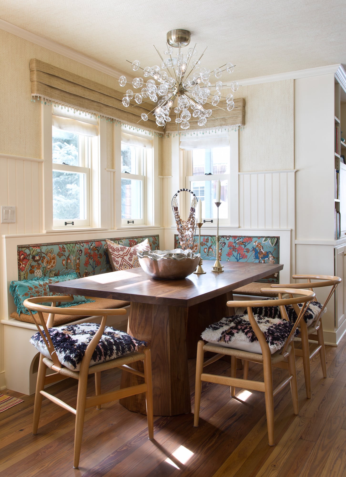 For a dining space in Crested Butte, Colorado, the designer upholstered a banquette in Hurlingham fabric from Cowtan & Tout and wrapped the space — even the ceiling — with Phillip Jefferies’ Diamond Weave grass-cloth wallcovering in Richmond Bisque. Photo by Emily Minton Redfield