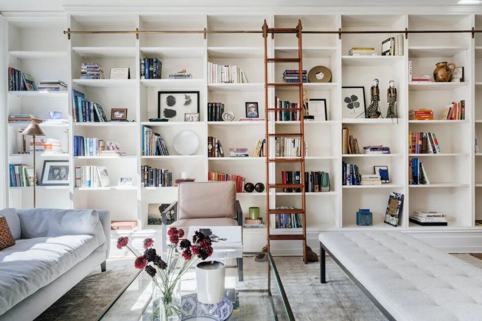 Lined with floor-to-ceiling bookshelves, a spacious living room in a townhouse designed by Emma Beryl Kemper reads as both library and salon.