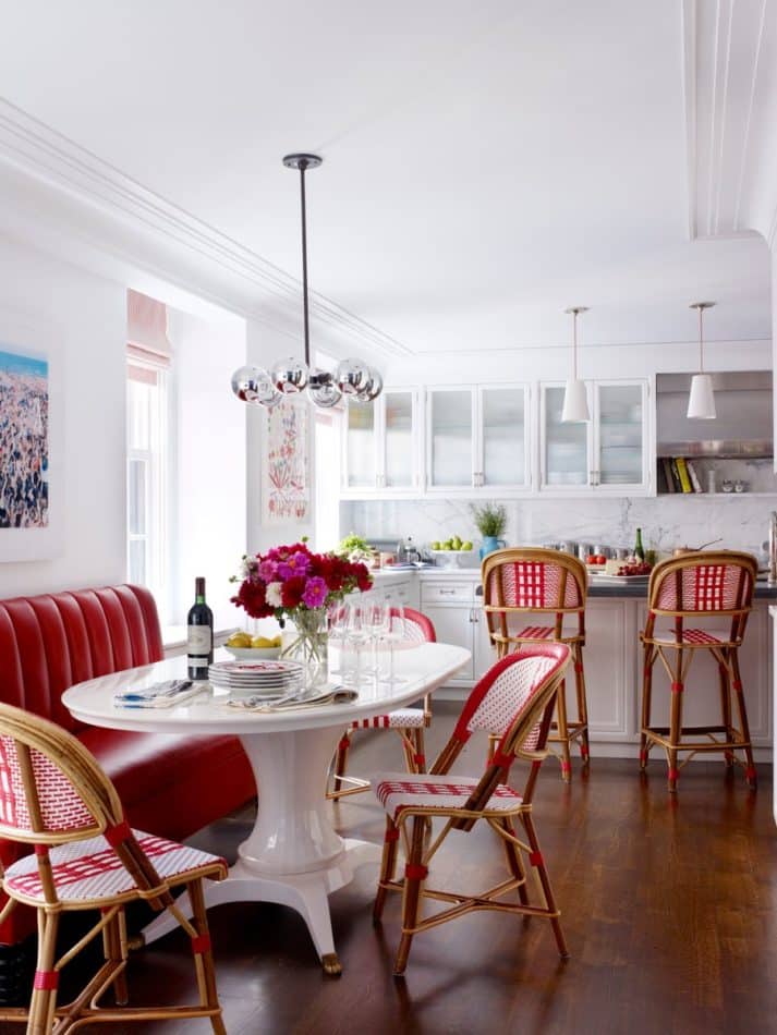 white kitchen with red chairs