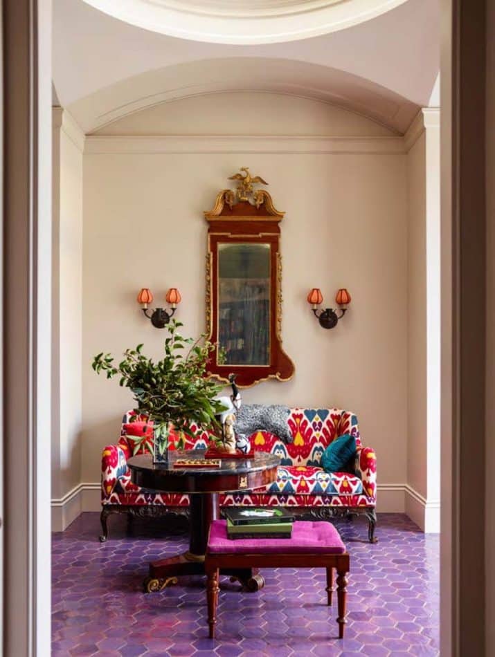 The front hall of Katie Ridder and Peter Pennoyer's home in Millbrook, New York, has a floor of purple Moroccan tiles.