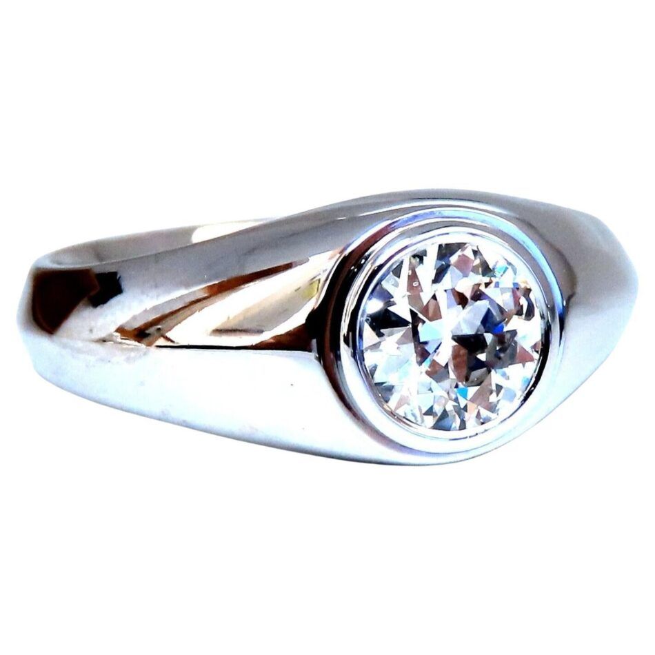 A flush-set solitaire engagement ring in a white gold band