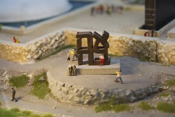 Tiny tourists pose on a public sculpture in Israel.