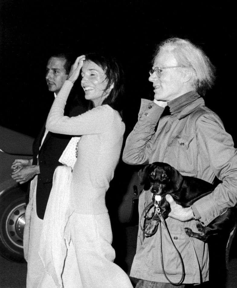 Fred Hughes, Lee Radziwill, and Andy Warhol with dog Archie, Montauk, New York, 1978, by Ron Galella