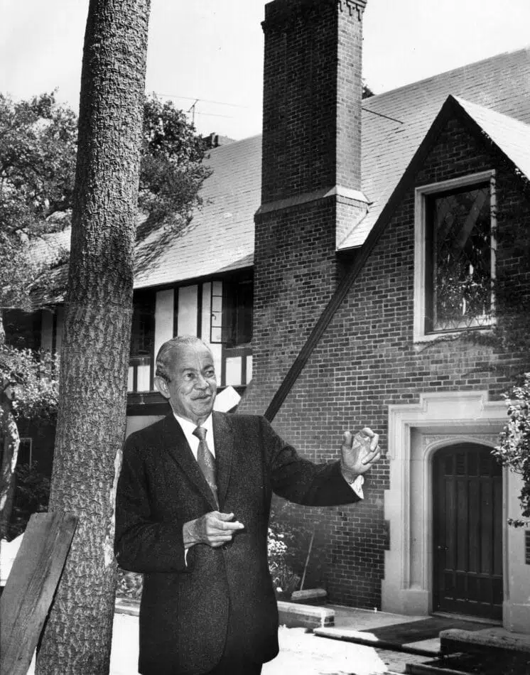 Architect Paul Revere Williams (1894 – 1980) stands before a Tudor mansion that he created in the Bel-Air neighborhood of Los Angeles, California, 1970. Created in 1928, the building was restored in 1970 and named a Design House West by the American Institute of Interior Designers. (Photo by Los Angeles Times via Getty Images)
