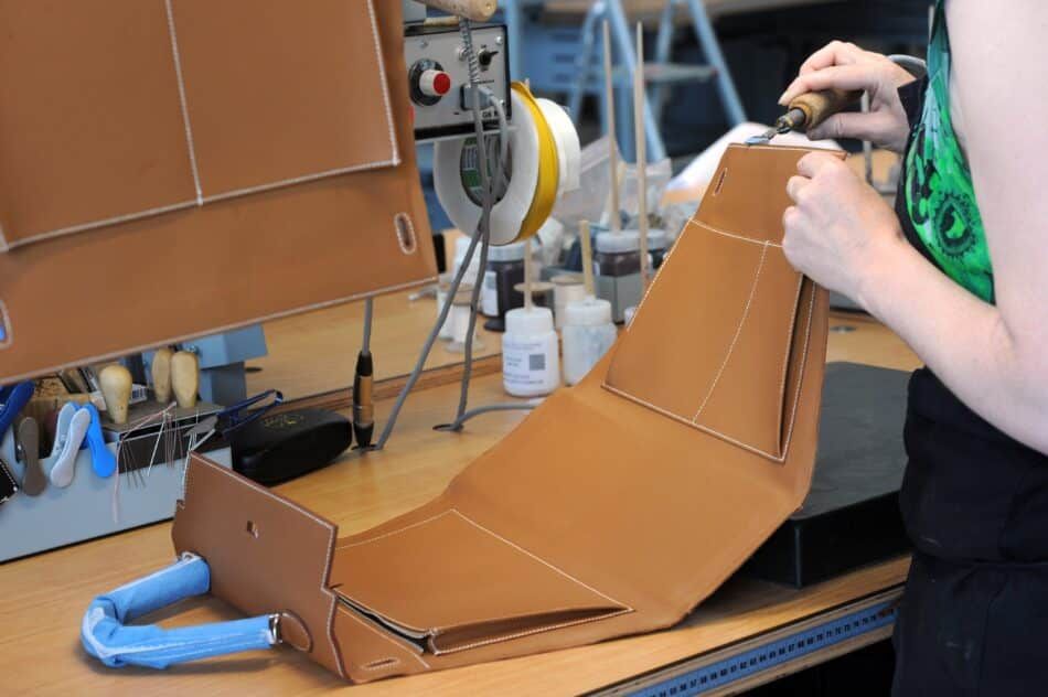 Hermes employee constructing a Kelly bag