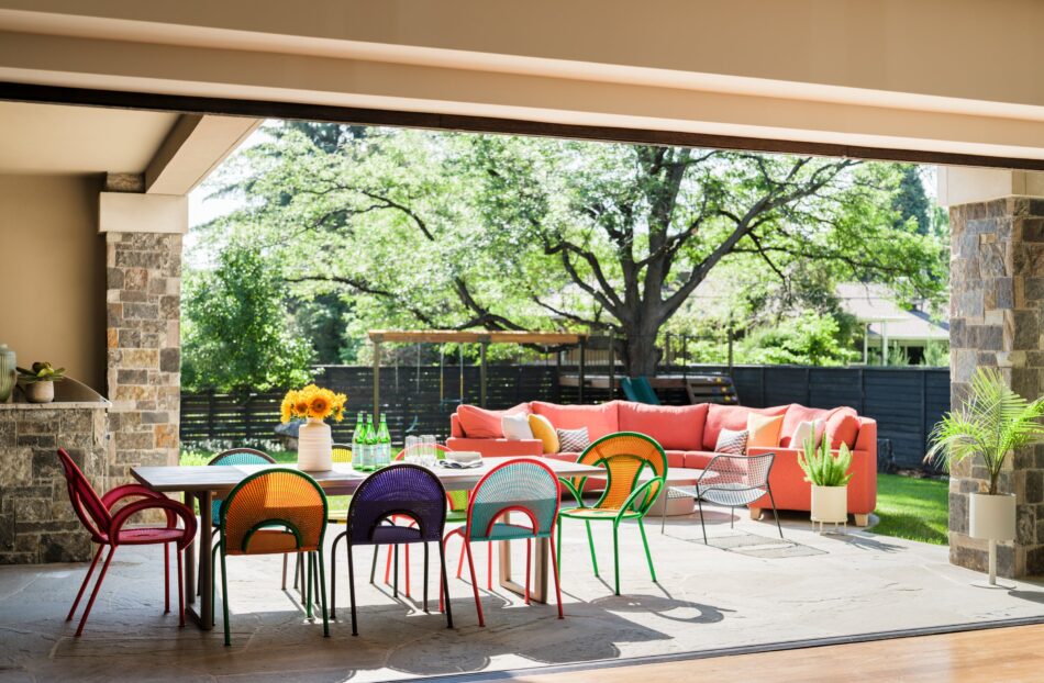 a patio dining table with colorful chairs
