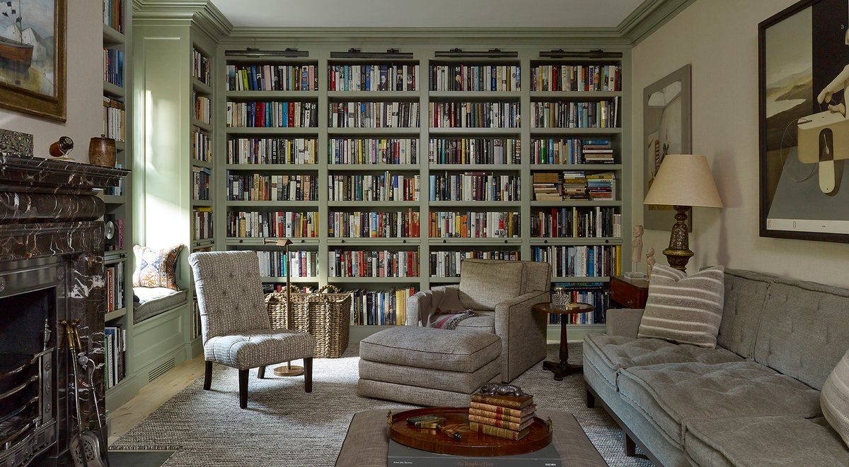 A cozy and inviting home library with floor-to-ceiling bookshelves