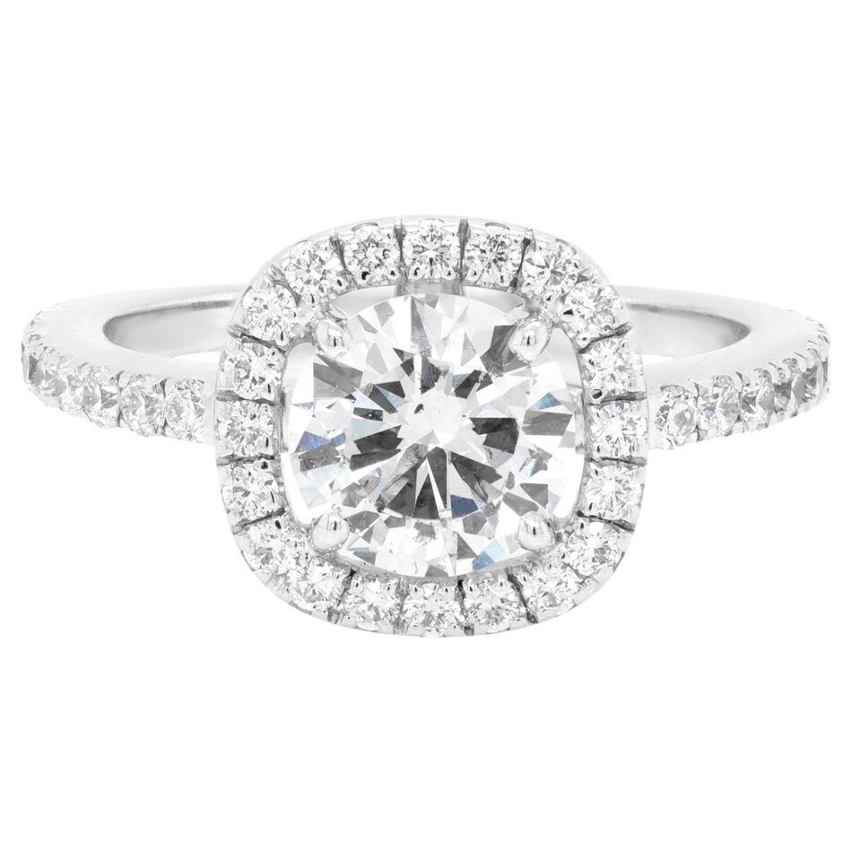 A round brilliant-cut diamond and white gold engagement ring in a halo setting